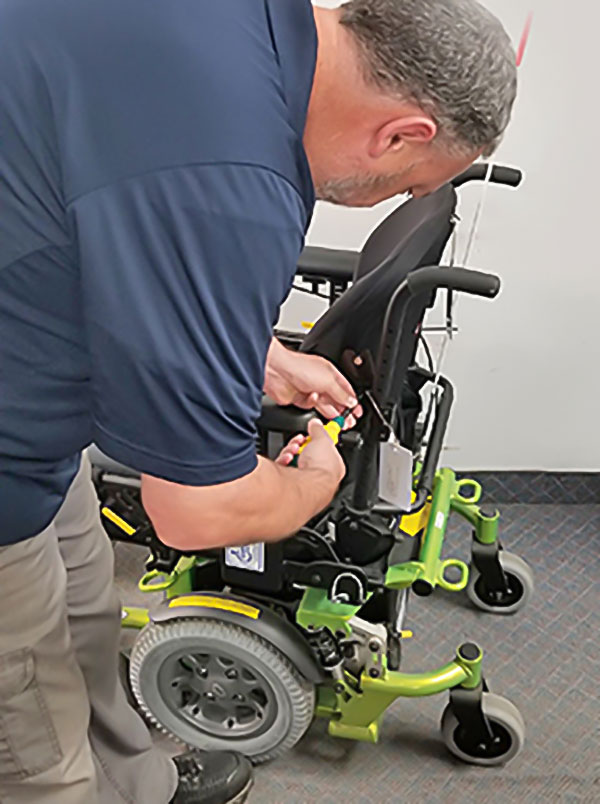 Technician repairing wheelchair